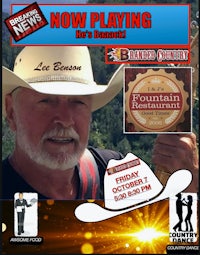 a man in a cowboy hat is holding a hat