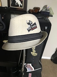 a hat is sitting on top of a guitar stand
