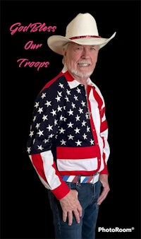 a man in a cowboy hat wearing an american flag shirt